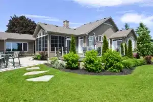 White-framed WeatherMaster™ Doors with glass panels, opening to a wooden deck.