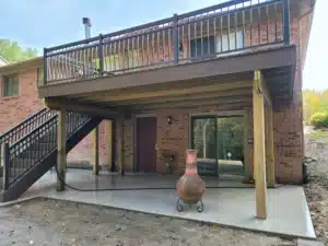 A well-constructed elevated deck with water-shedding decking, preventing water from passing through, keeping the area below dry and usable.