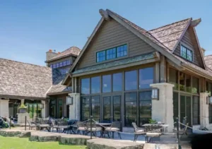 A modern building featuring large WeatherMaster™ Windows with black frames, providing a stylish and energy-efficient glass solution.