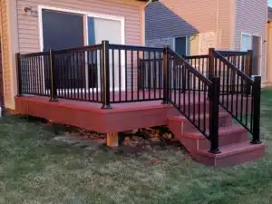 Black aluminum picket railing installed on a raised wooden deck with stairs, providing a stylish and secure outdoor barrier