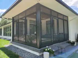 Modern screen room Model 200 with black-framed panels, offering a stylish enclosed outdoor space with ample natural light and ventilation
