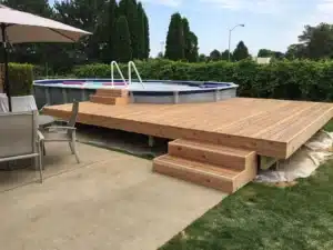 Trex Composite Decking surrounding an above-ground pool with built-in steps, creating a stylish and durable outdoor relaxation space