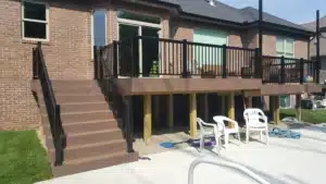 Water Shedding Decking system installed on an elevated deck with black railings, designed to keep the area below dry and functional